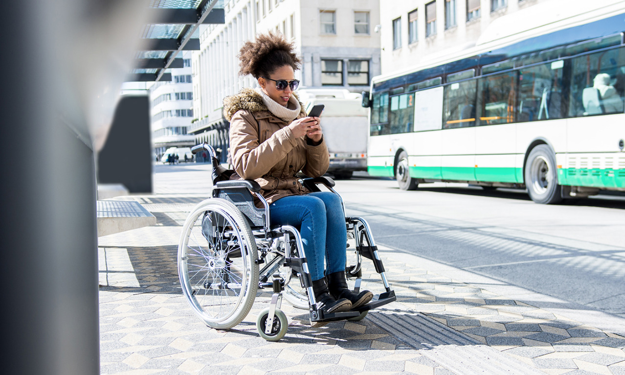 Smart disabled. Public transport woman with wheelchair.